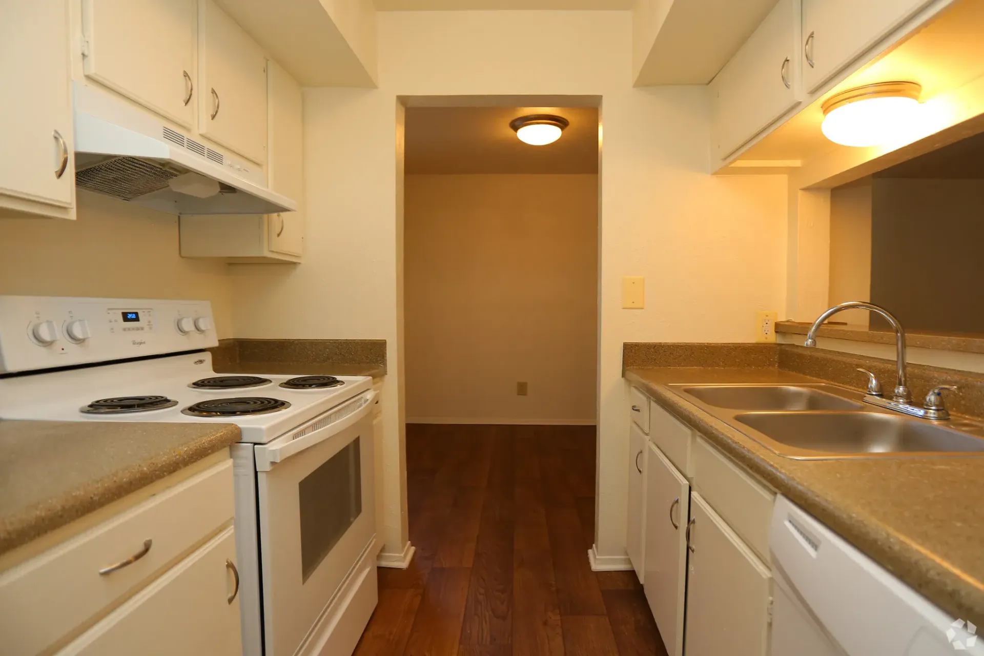 White kitchen with stove, cabinets & sink at Brookview, offering Odessa apartments for rent.