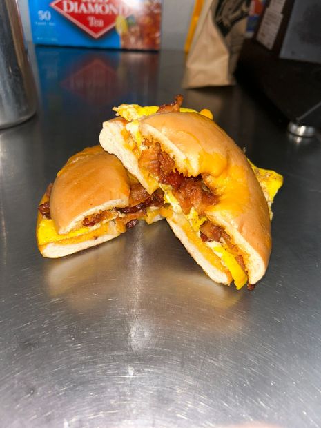 A bacon egg and cheese sandwich is cut in half