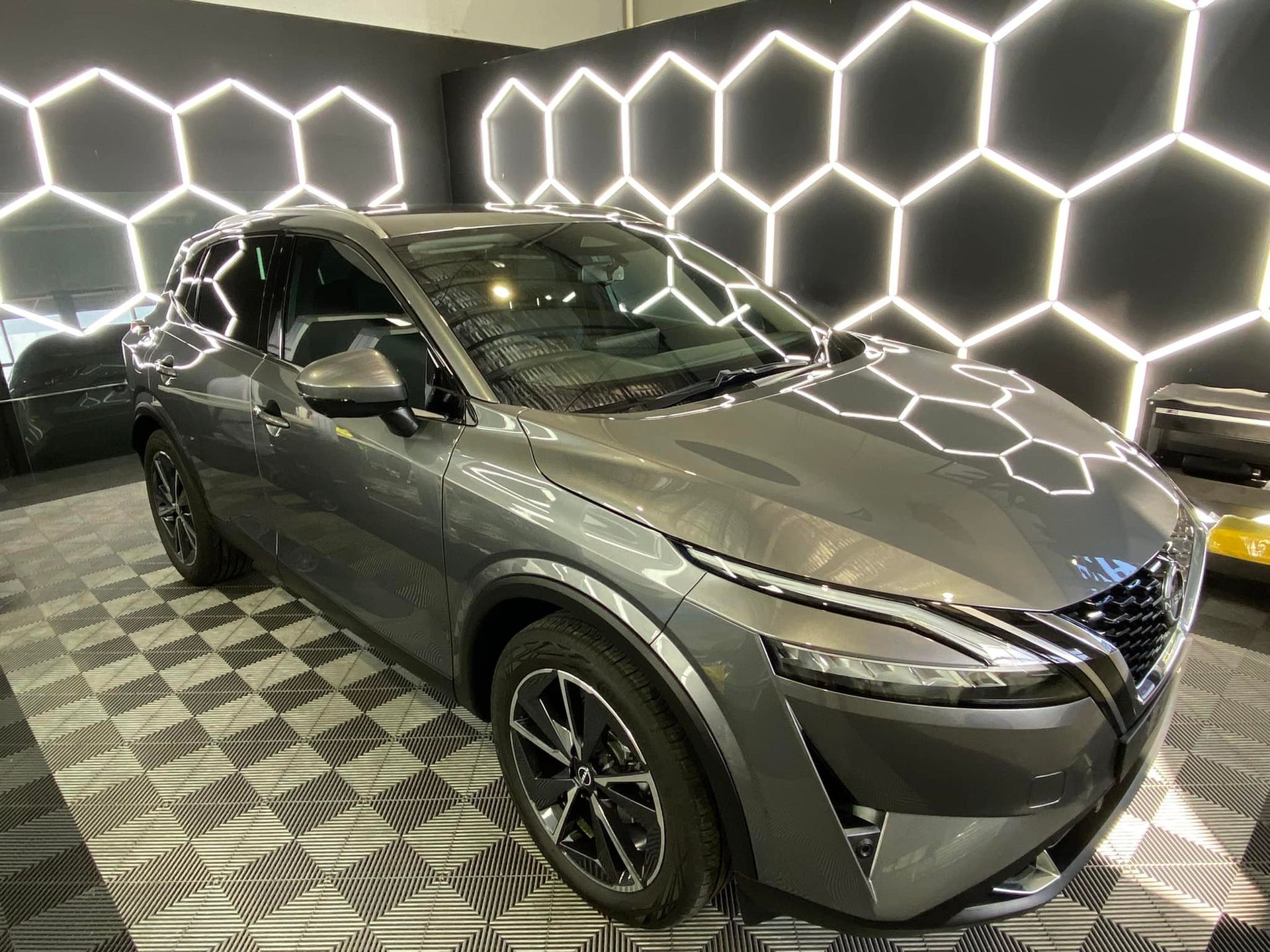 A nissan qashqai is parked in a showroom.