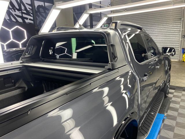A black truck is parked in a garage - window tinting by Tint Wright Brisbane