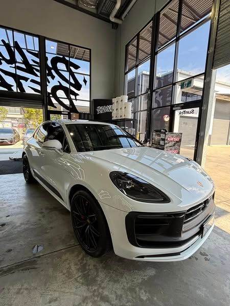A white porsche macan turbo is parked in a garage - window tinting by Tint Wright Brisbane