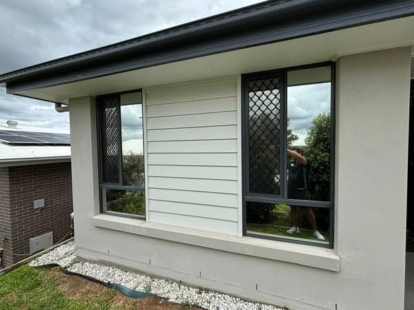 A house with a lot of windows on the side of it - window tinting by Tint Wright Brisbane