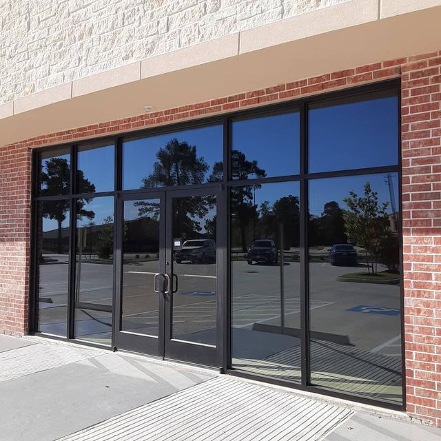 A building with a lot of windows and a brick wall - window tinting by Tint Wright Brisbane