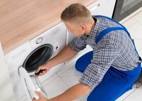 Worker In Overall Fixing Washer - Appliance Repair in Newbury Park, CA