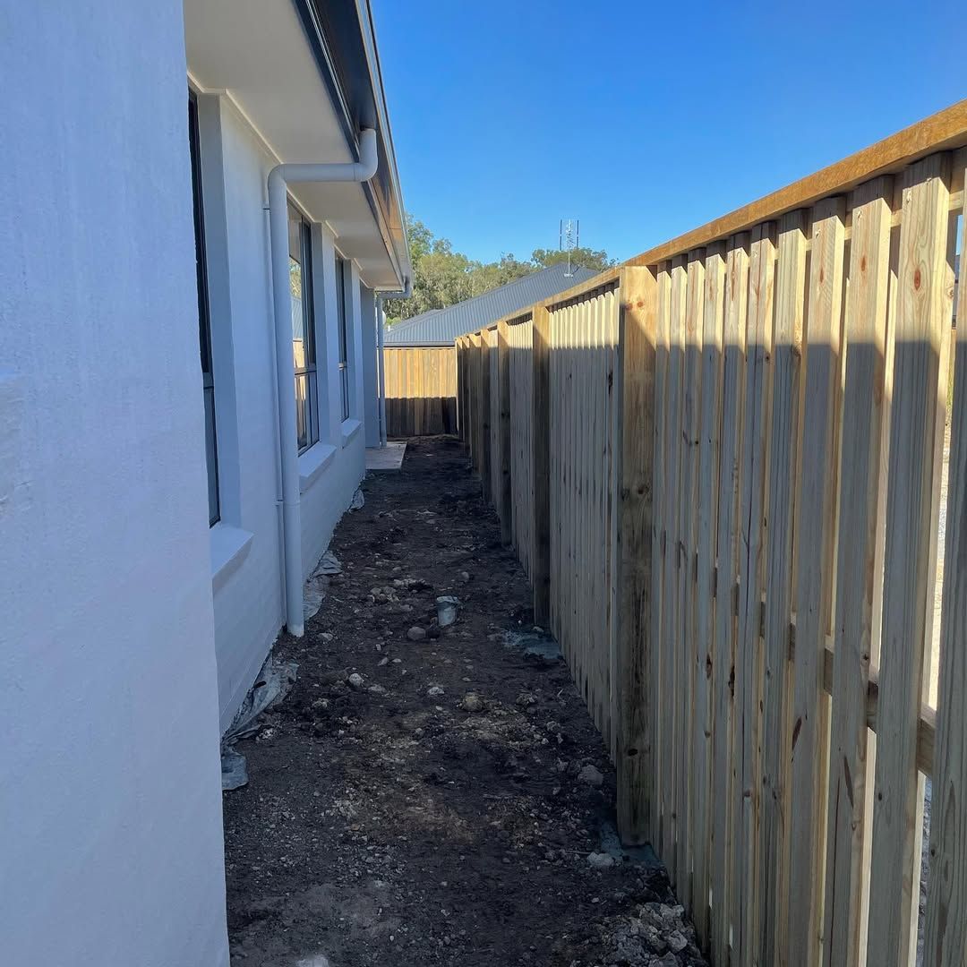 A wooden fence along the side of a house — Turnscape Landscaping in Palm Beach, QLD