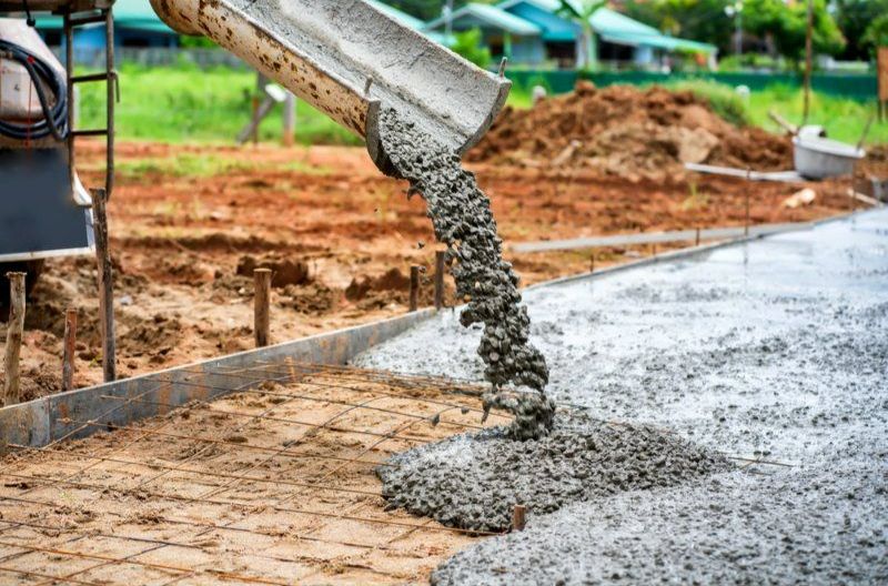 A Concrete Truck is Pouring Concrete on a Construction Site — Turnscape Landscaping in Burleigh Heads, QLD
