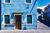 A blue building with a brown door and windows