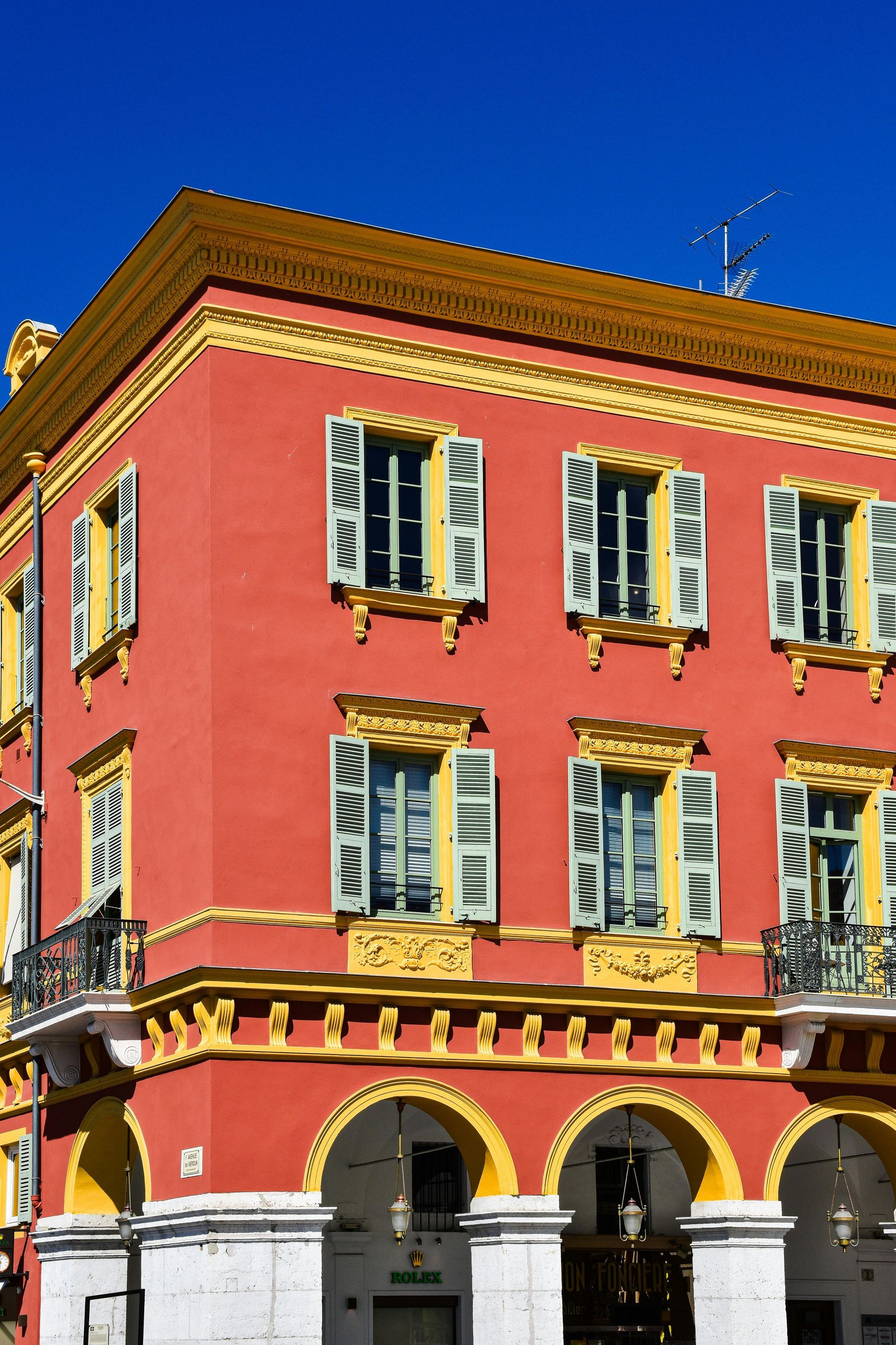 A red building with a blue sky in the background