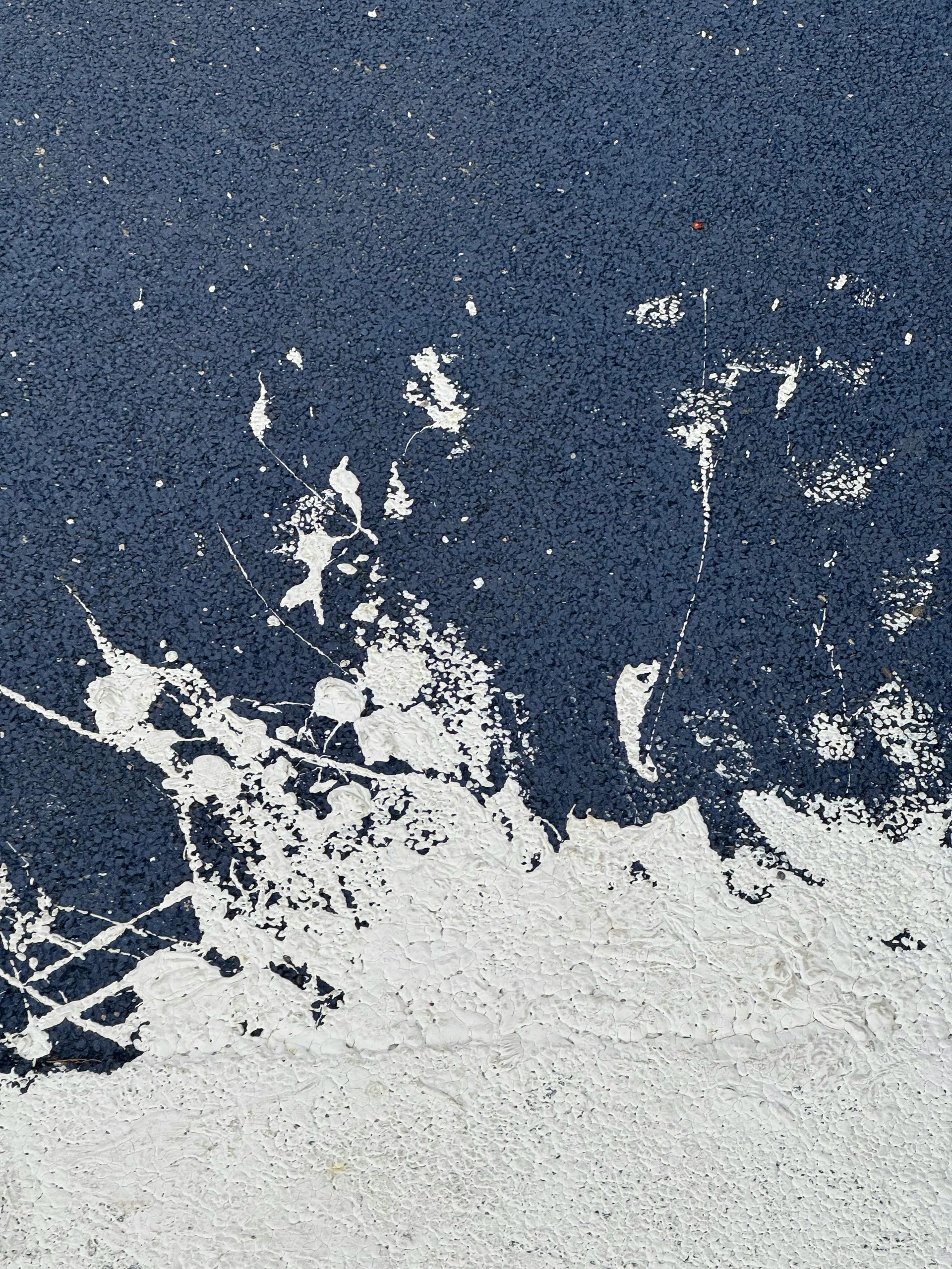 A close up of a blue wall with white spots on it