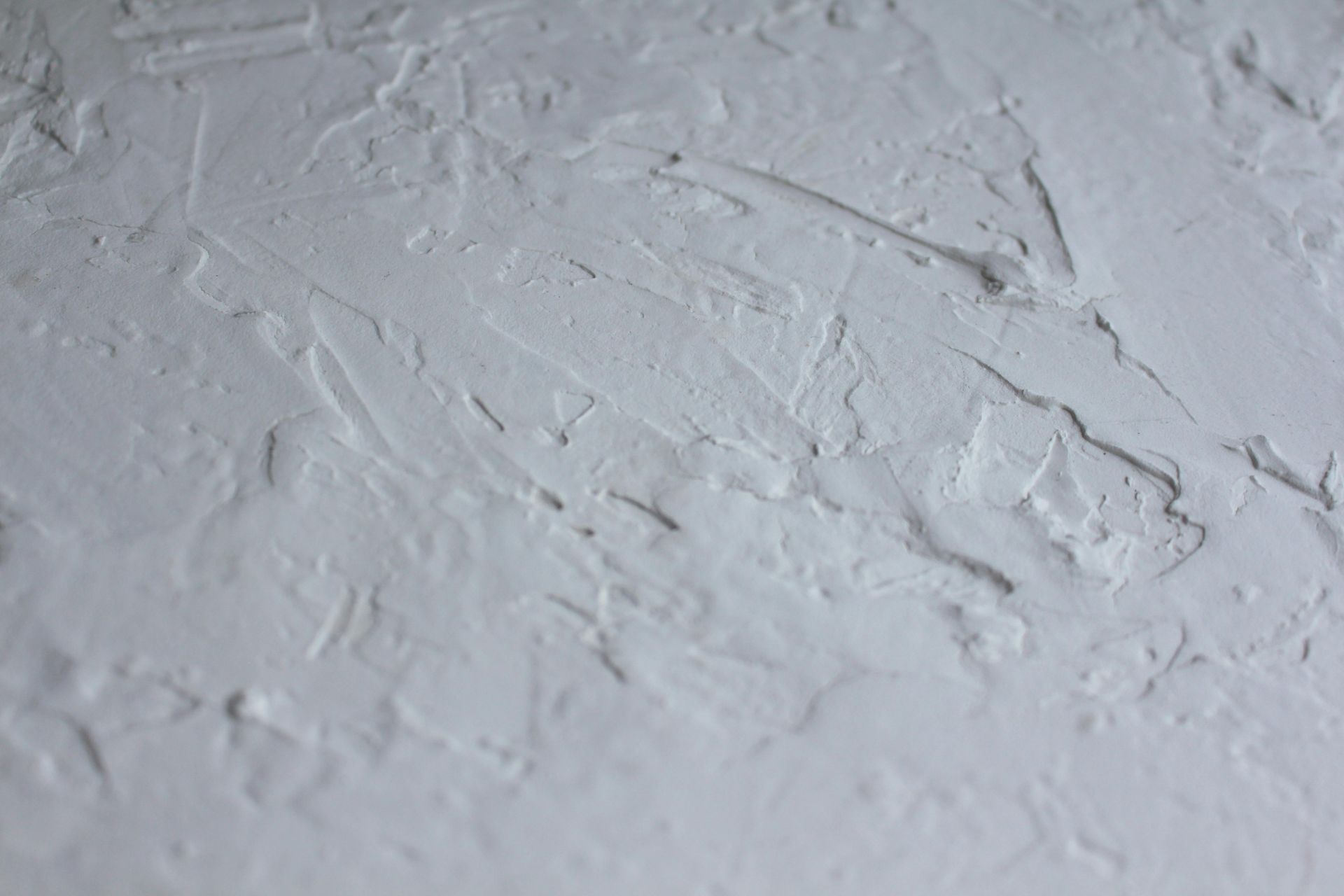 A close up of a white wall with a texture.