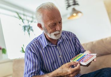 Senior Man Taking Pills at Home — Plano, TX — UBP Insurance