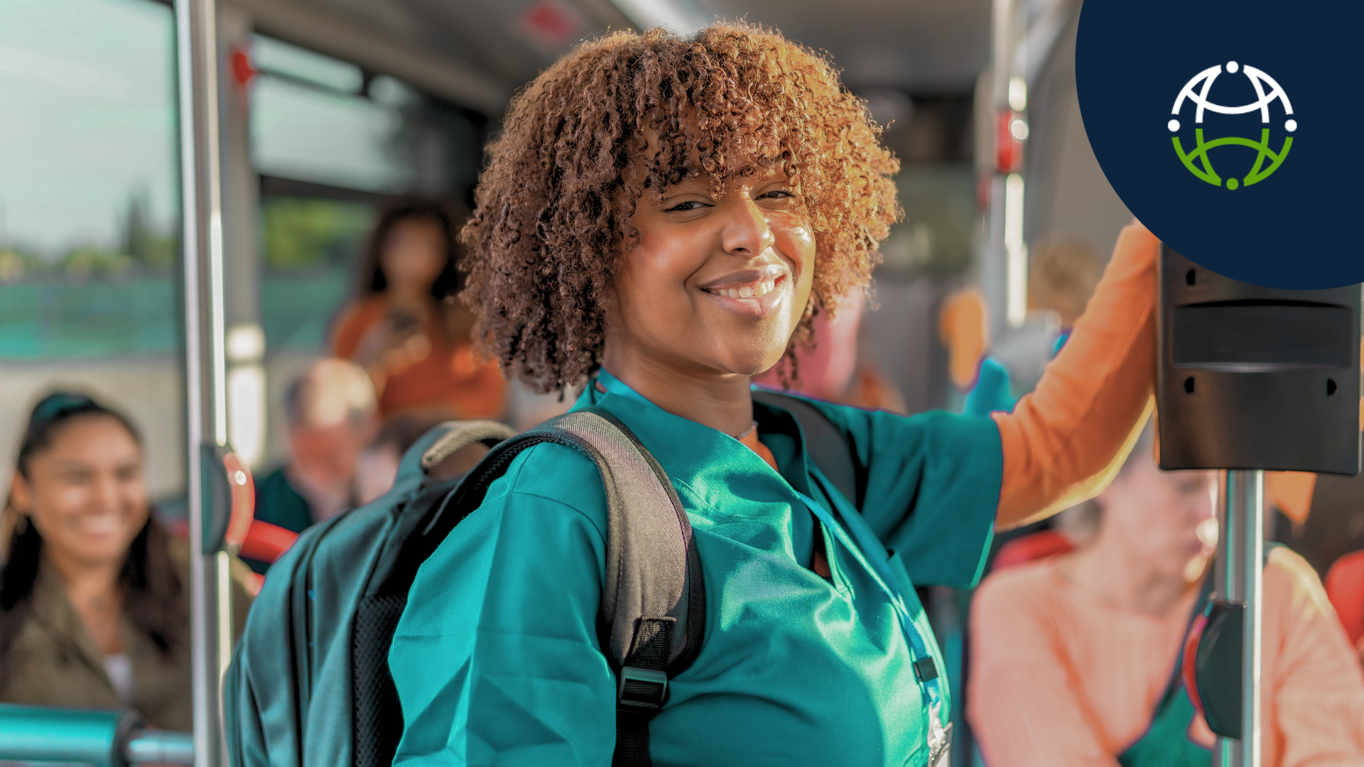 nurse with backpack smiling while standing up inside city bus
