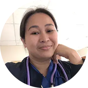 A woman is wearing a stethoscope around her neck and smiling.
