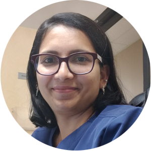 A woman in a blue scrub top is smiling in a circle.