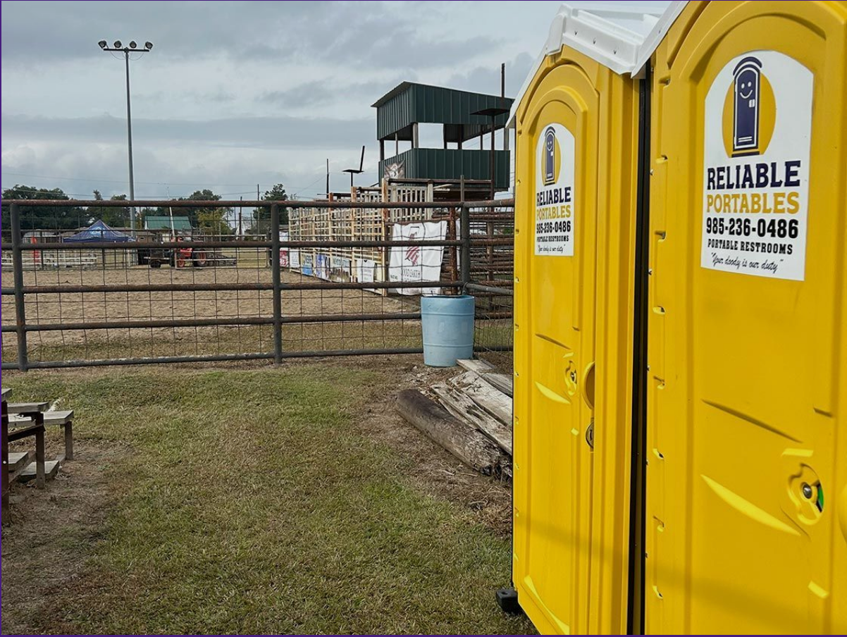Two yellow portable toilets with reliable portables written on them