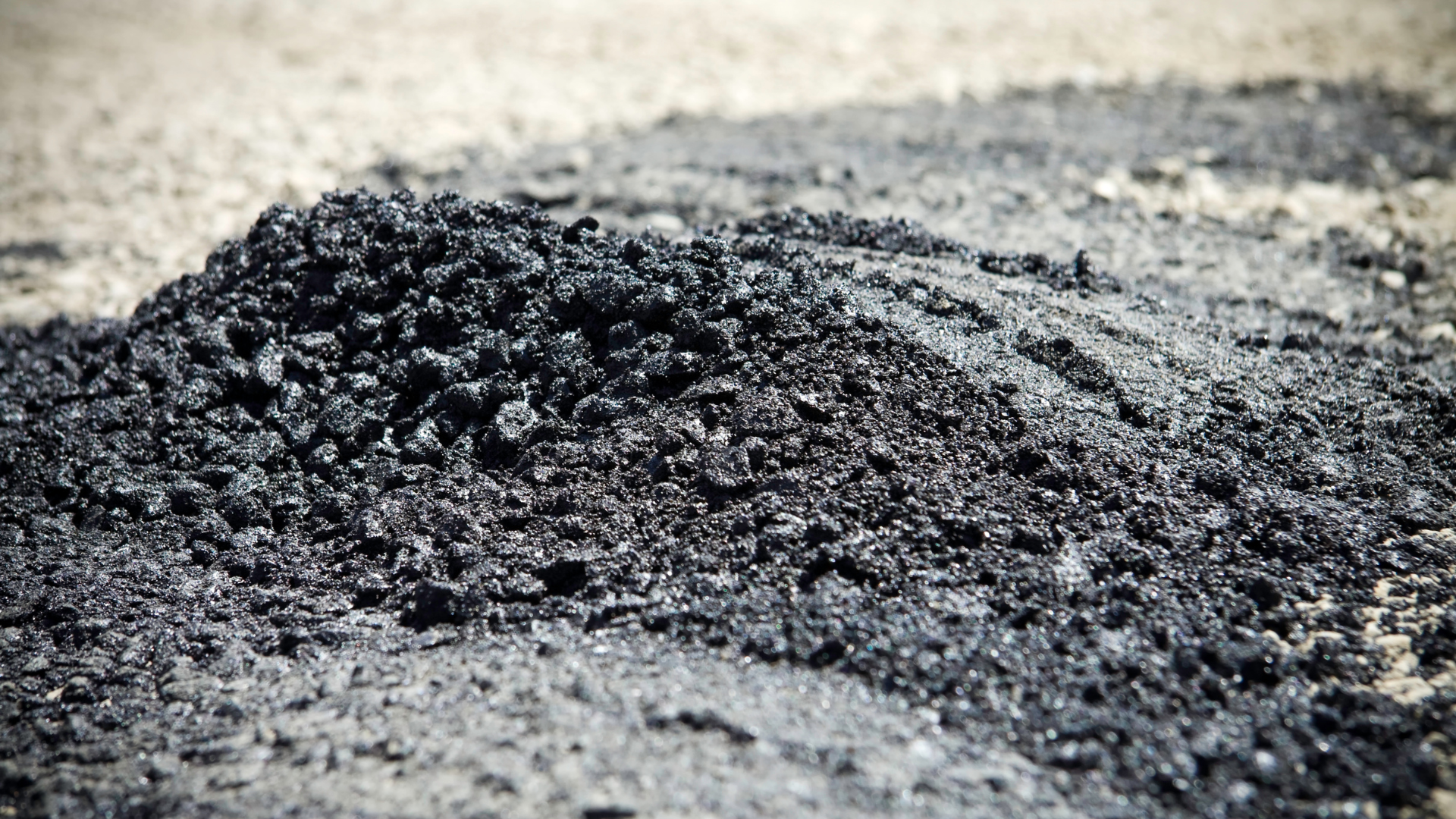 A living room with a white couch , chairs , coffee table and lamp.
