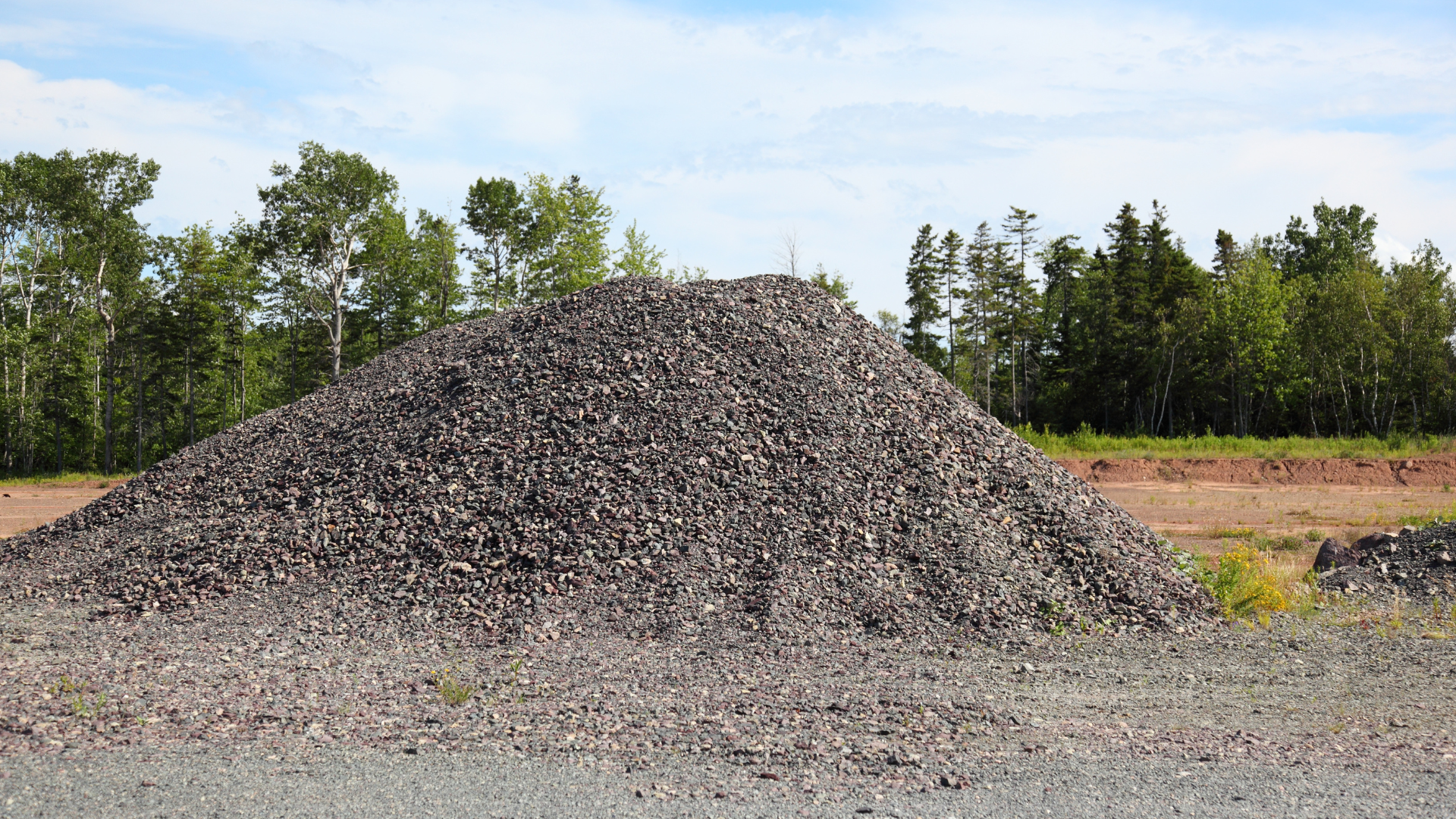 A pile of trash is sitting on the side of a building.