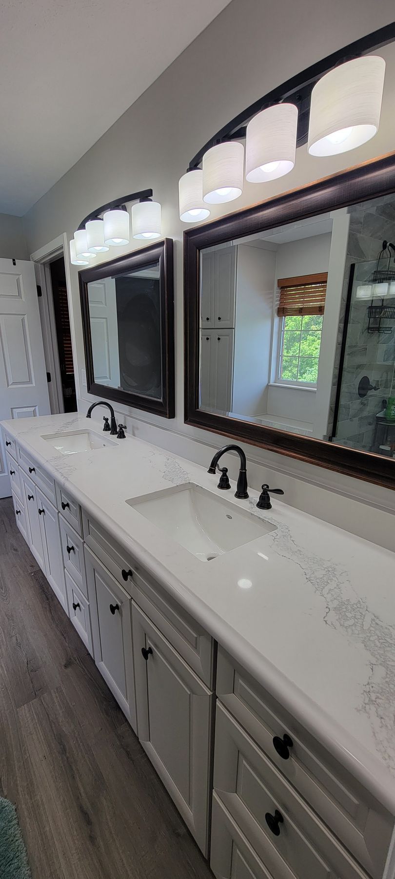A bathroom with two sinks and two mirrors.
