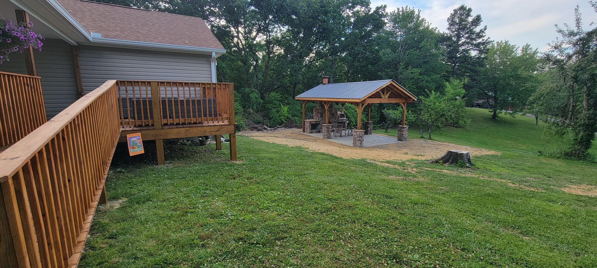 A house with a deck and a gazebo in the backyard.