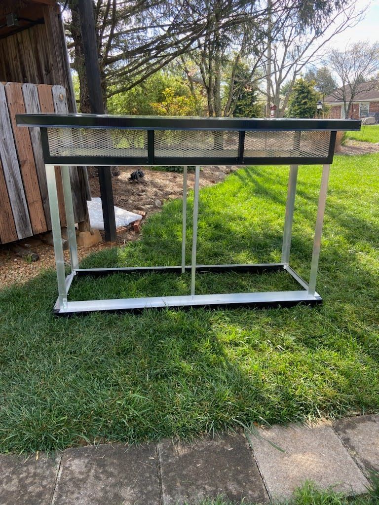 A table is sitting on top of a lush green field.
