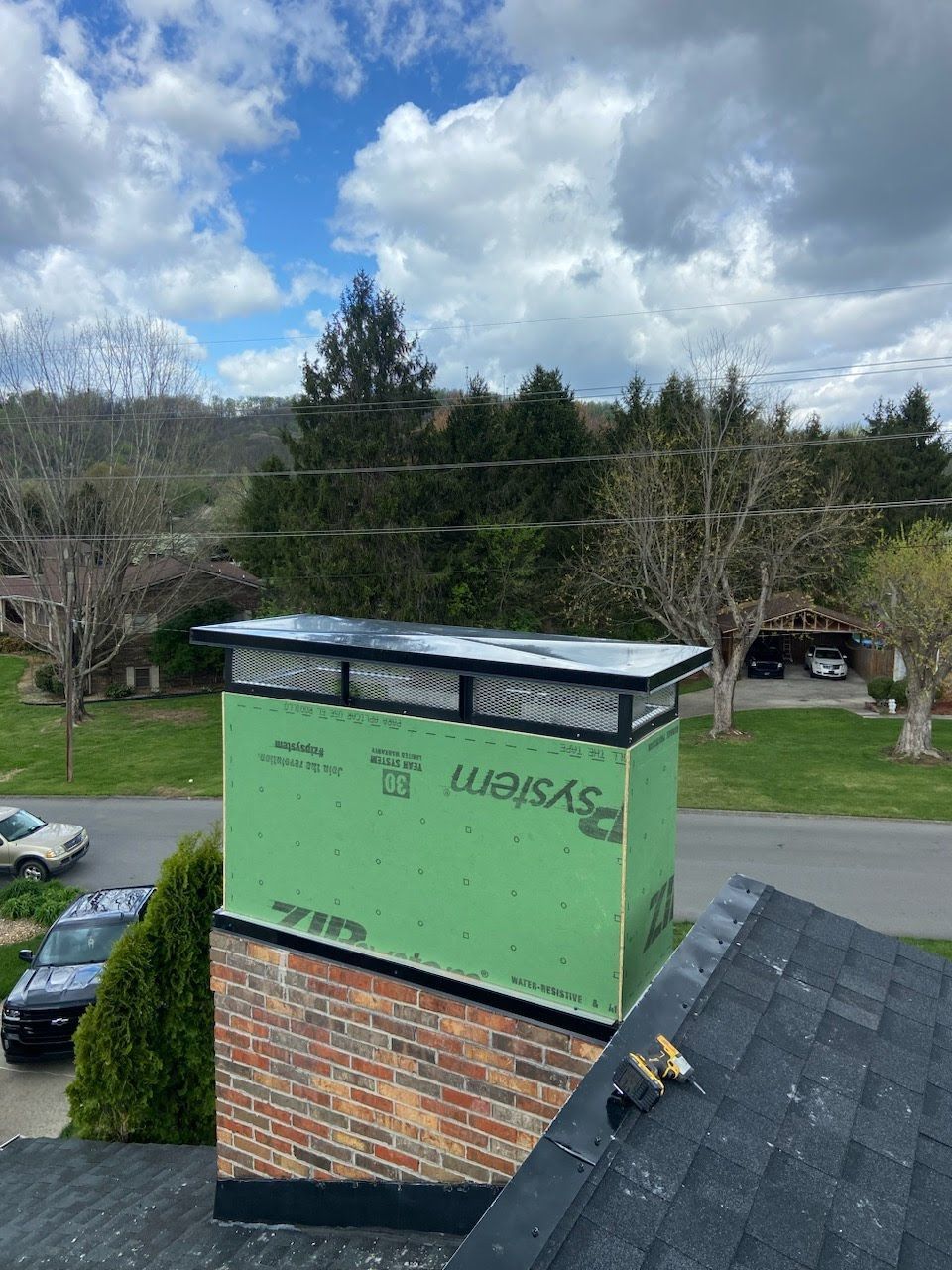 A chimney is being installed on the roof of a house.