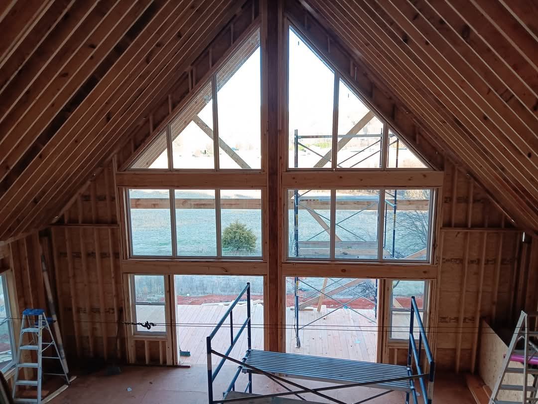 The inside of a building under construction with a lot of windows.