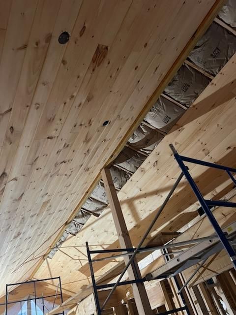 A wooden ceiling with a scaffolding in front of it