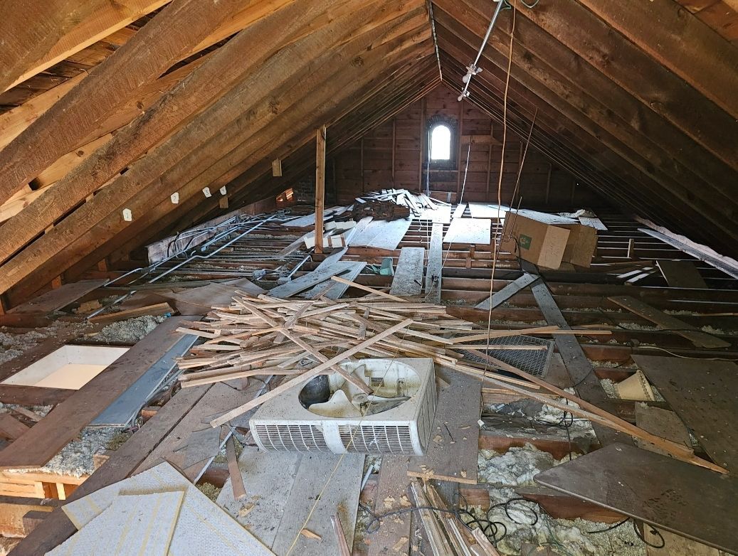 An attic with a lot of wood and a window.