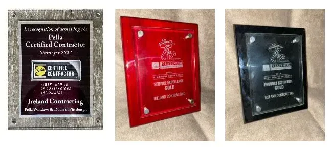 Three awards: silver, red, and black plaques. Each features text and logos.