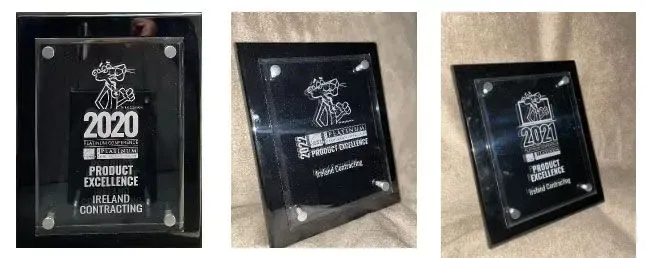 Three views of a black and clear glass award with the year 2020 on it.