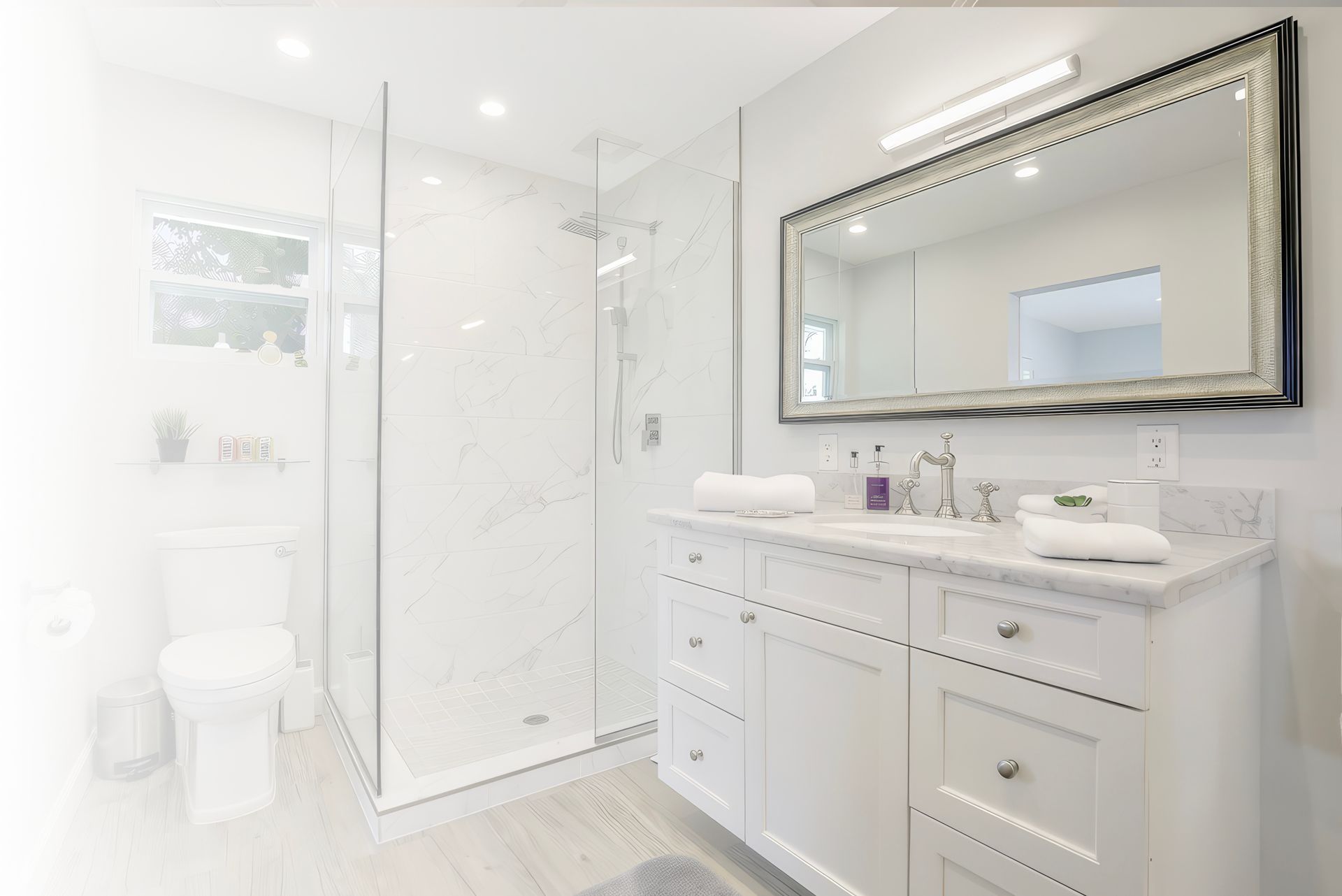 A bathroom with a walk in shower , sink , mirror and toilet.