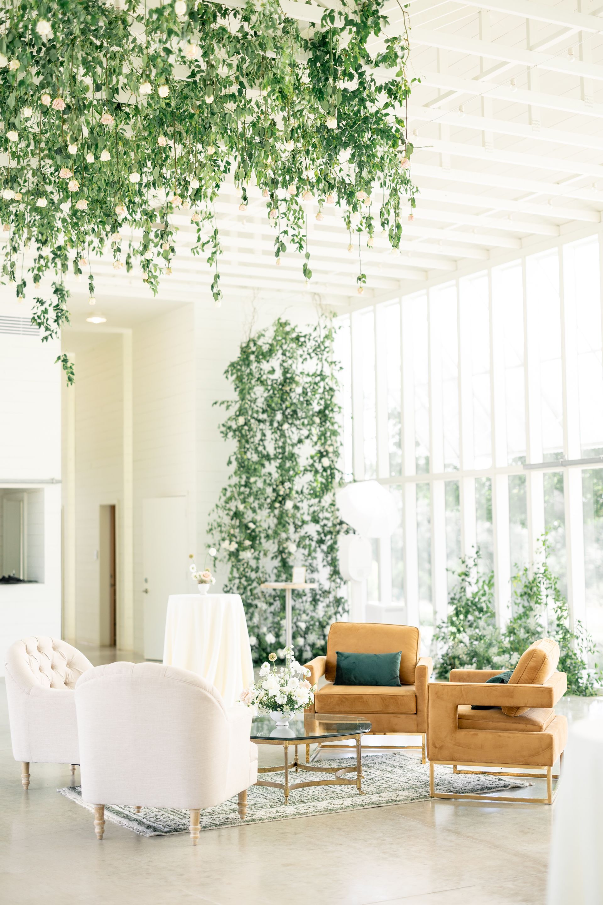 Prospect House Gallery area with white walls, floral decorations, and gold and pink furniture.