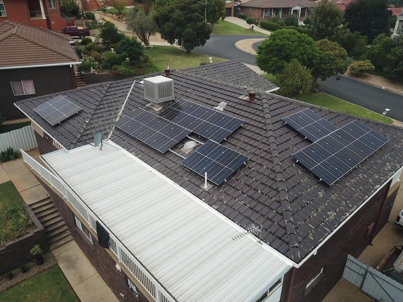 An Aerial View of A House with Solar Panels on The Roof — Brent Hawe Solar & Electrical in Glenfield Park, NSW