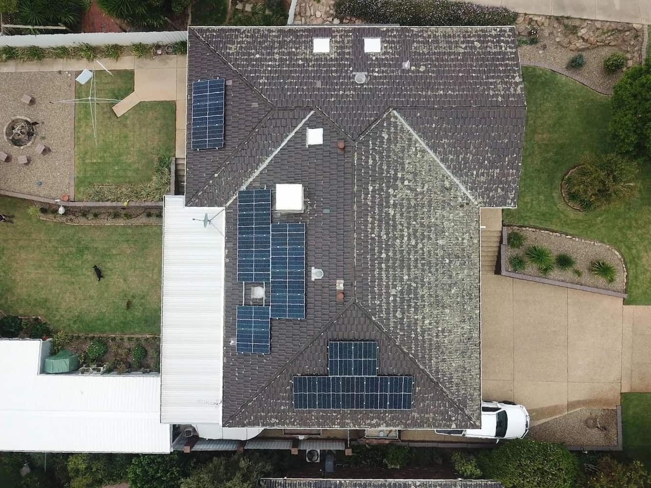 An Aerial View of A House with Solar Panels on The Roof — Brent Hawe Solar & Electrical in Glenfield Park, NSW