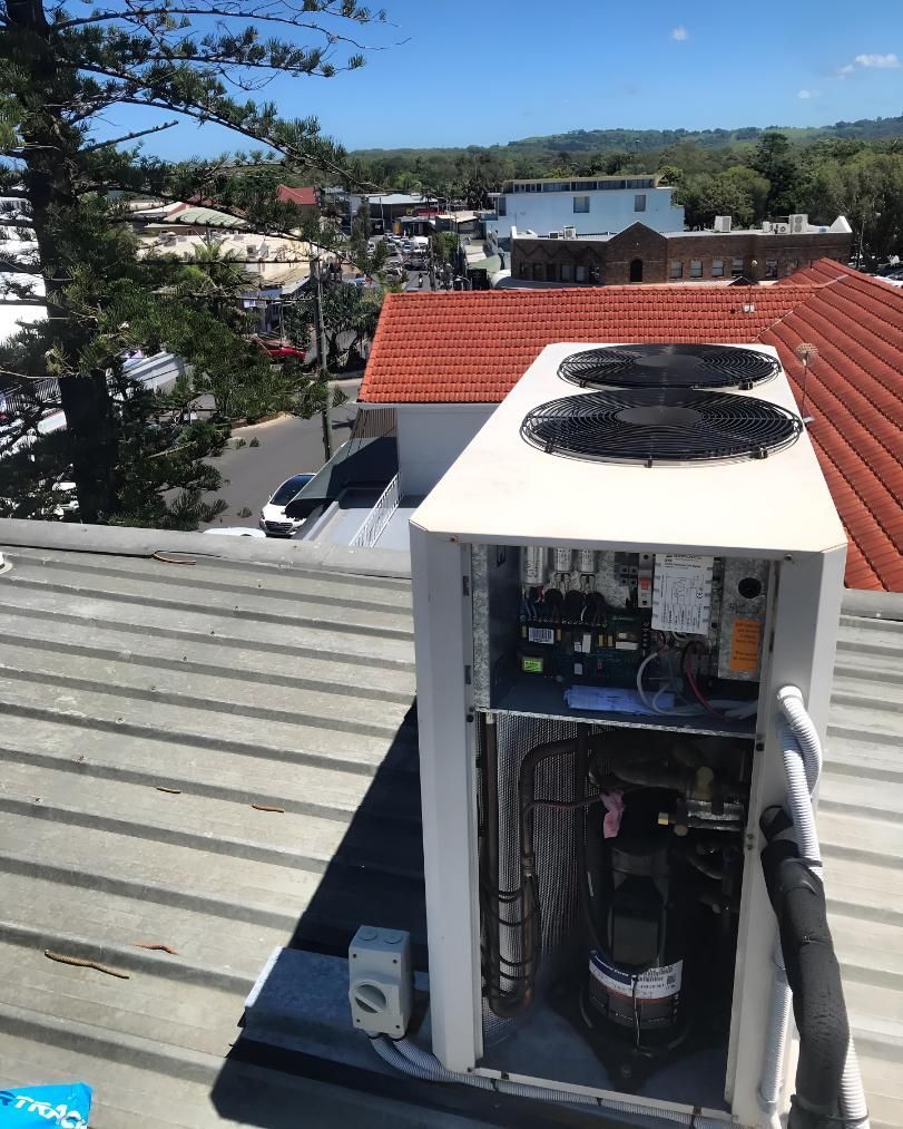 An air conditioner is sitting on the roof of a building