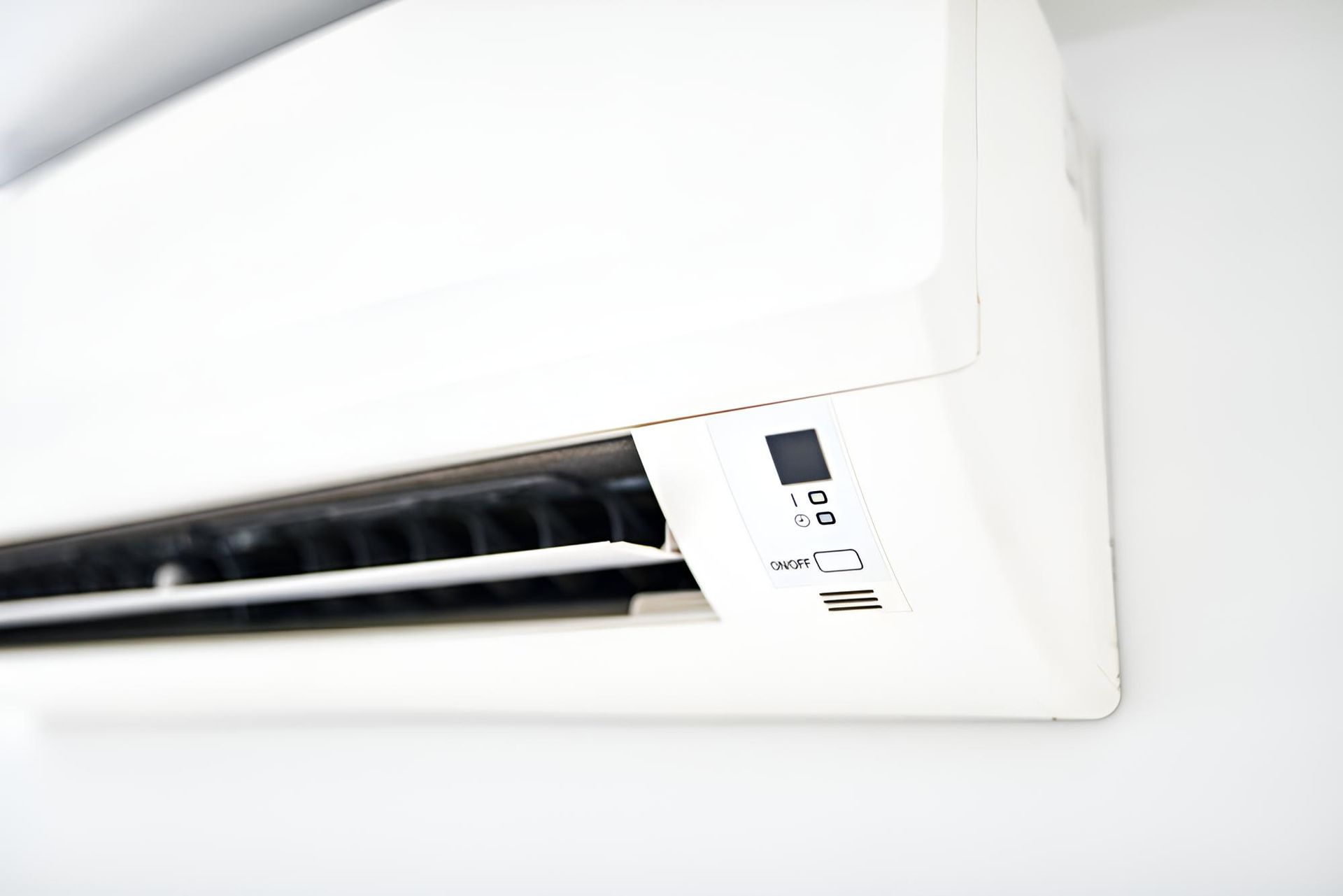 White Air Conditioner is Hanging on a White Wall — Coolman Airconditioning in Broken Head, NSW