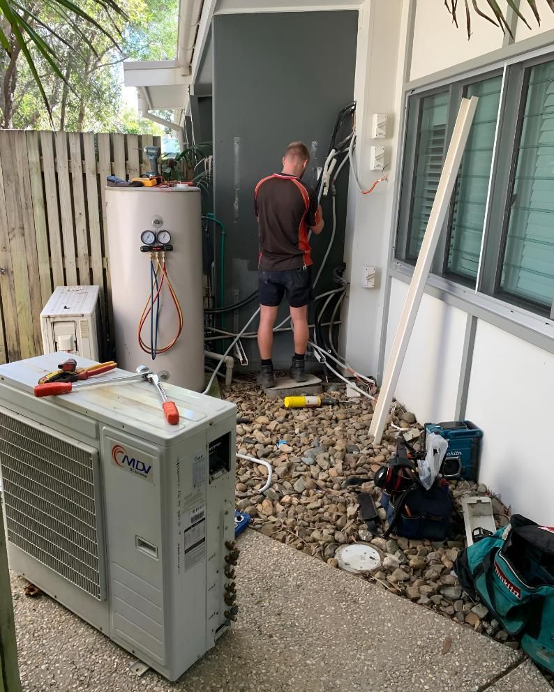 Man is Working on an Air Conditioner — Coolman Airconditioning in Goonellabah, NSW