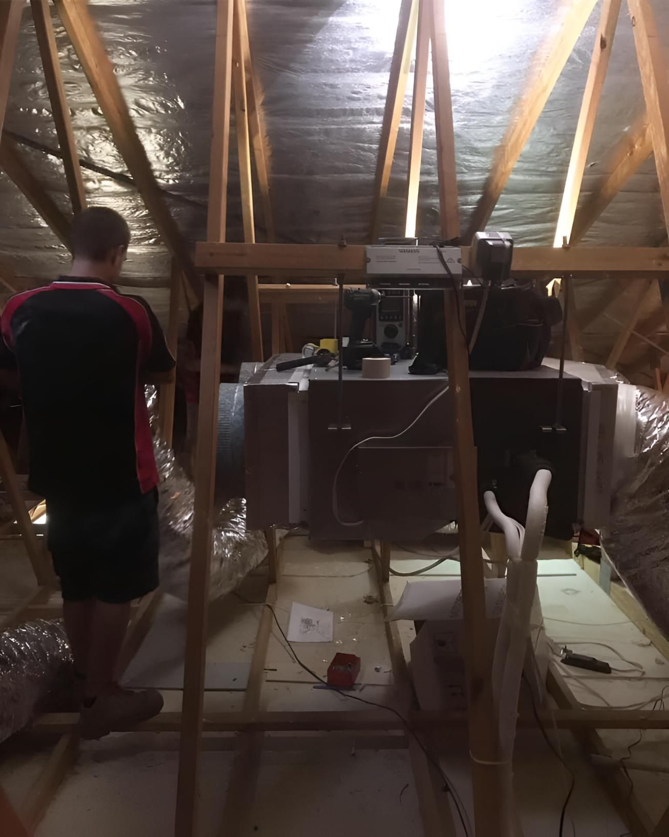 Man Maintaining Air-condition on Attic — Coolman Airconditioning in Pottsville, NSW