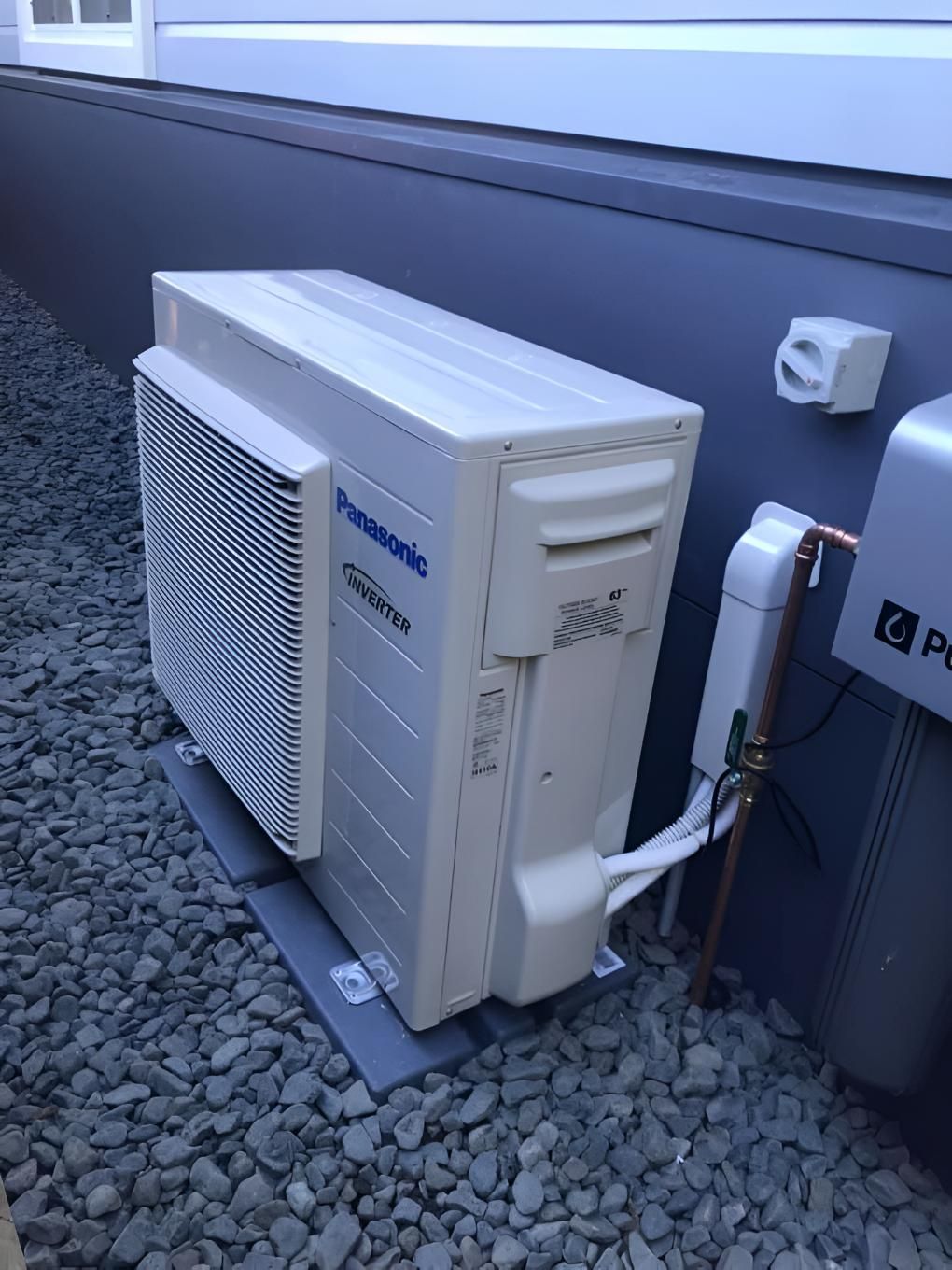 Panasonic Air Conditioner is Sitting Outside of a Building — Coolman Airconditioning in Wollongbar, NSW
