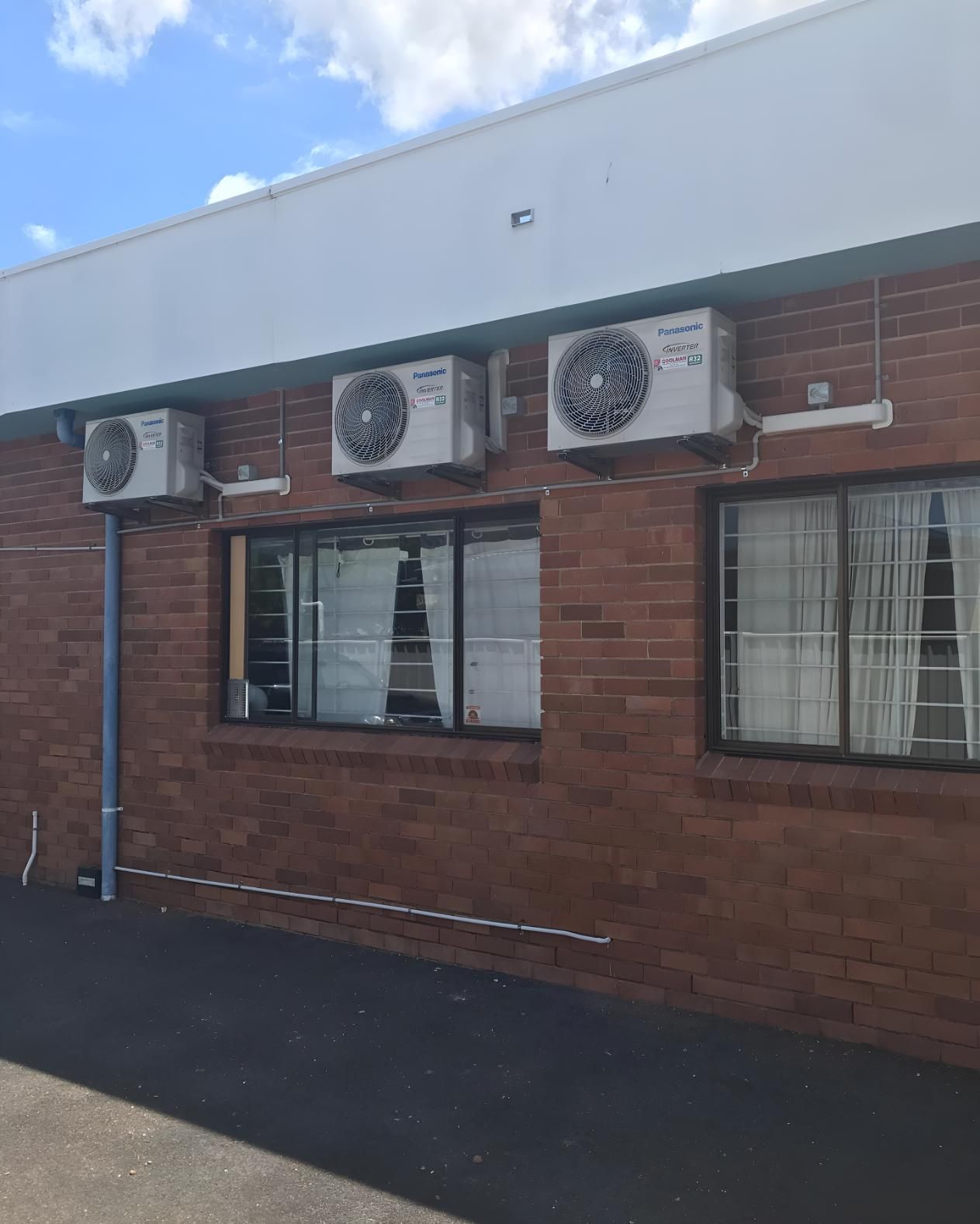 Brick Building With Three Air Conditioners — Coolman Airconditioning in Ballina, NSW
