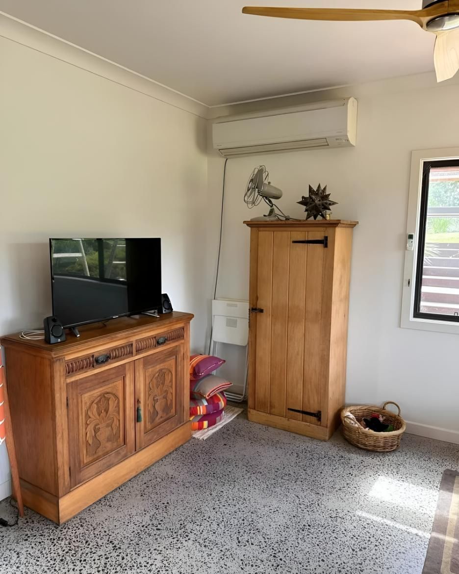 Living Room With a Wooden Cabinet — Coolman Airconditioning in Broken Head, NSW