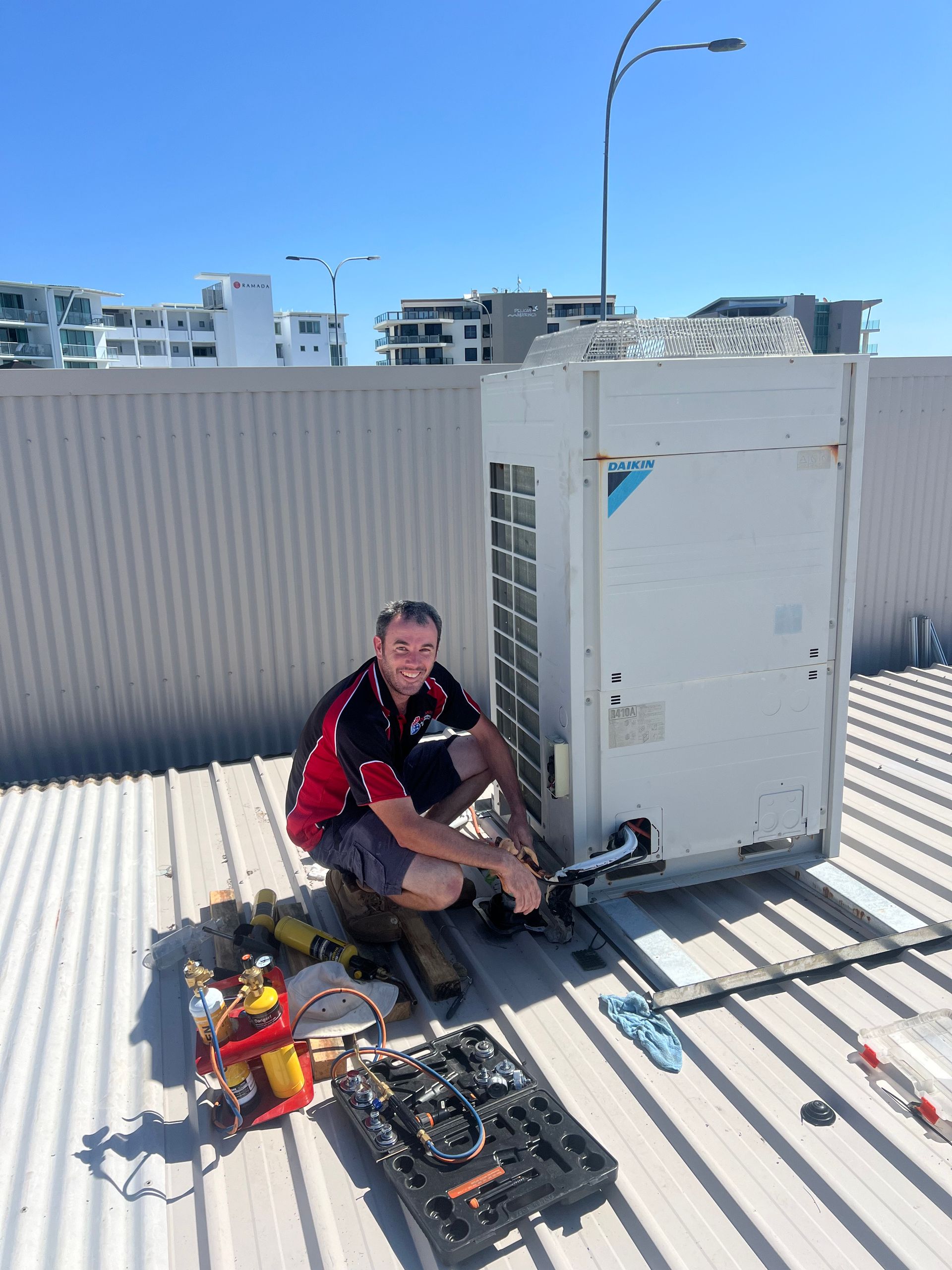 White Commercial Air Conditioner with a male technician — Coolman Airconditioning in Lennox Head, NSW