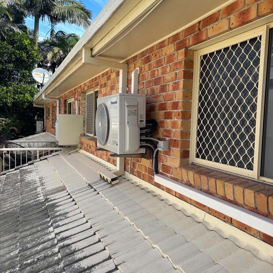 Air Conditioner is Mounted on the Side of a Building — Coolman Airconditioning in Broken Head, NSW