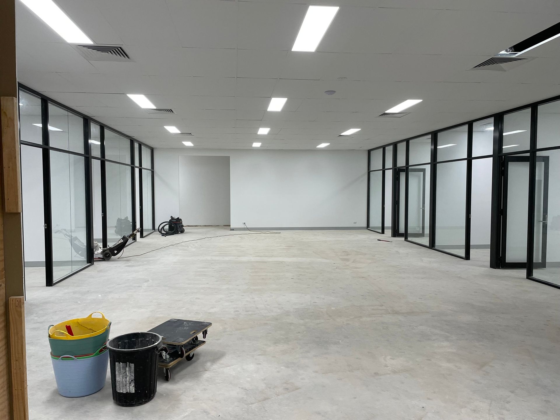 Office Space with Glass-Walled Rooms and Unfinished Concrete Floor — Completely Plastered North Coast in Goonellabah, NSW