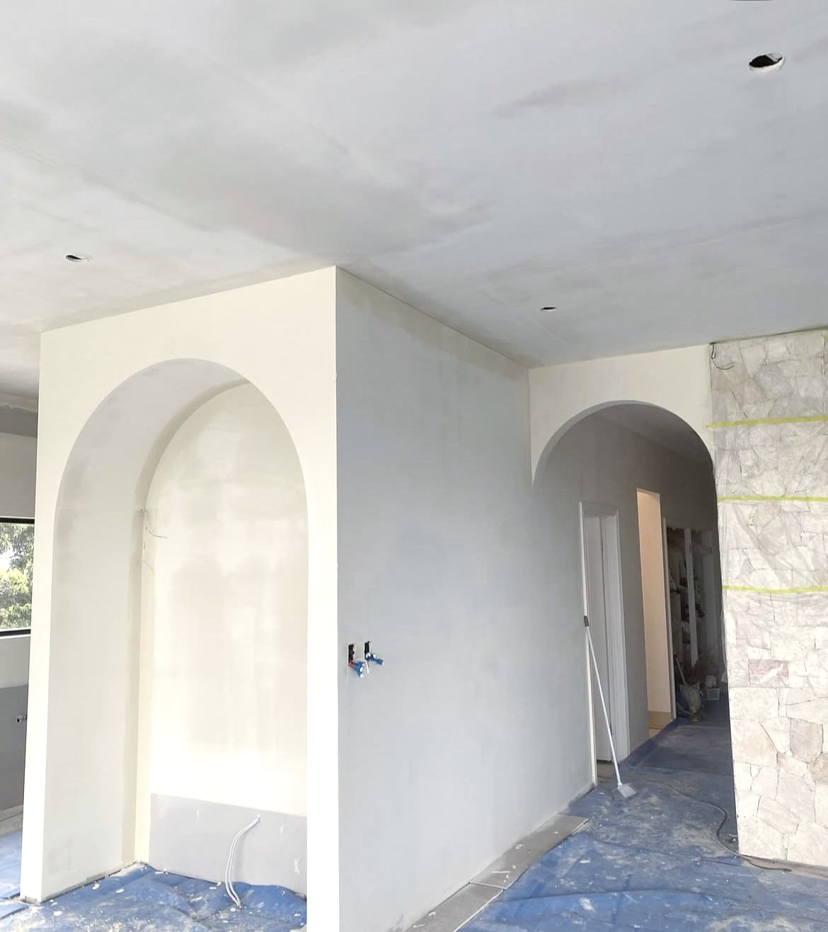 Interior under construction with arched doorways and partially finished walls — Completely Plastered North Coast in Goonellabah, NSW