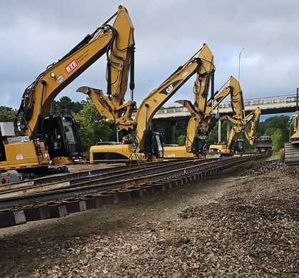 Hulcher replacing railroad tracks using four excavators. 
