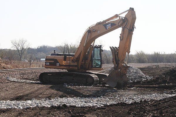 Hulcher excavators dig up soil during a grade stabilization / erosion control project