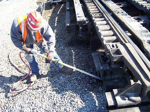 Hulcher railroad professional uses an Air Spade to perform air excavation and winterizing on a retarder