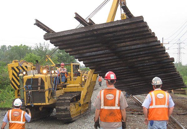 Sideboom positions a track panel for installation