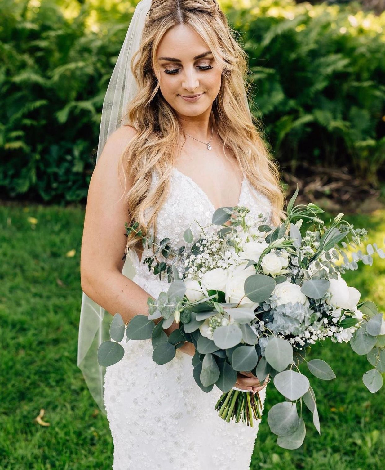 Bride holding a wedding floral arrangement